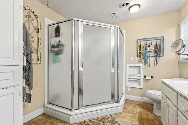 a bathroom with a glass shower door