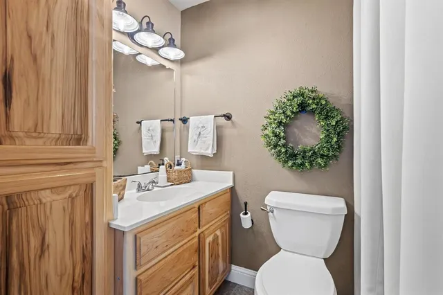 a bathroom with a toilet sink and mirror