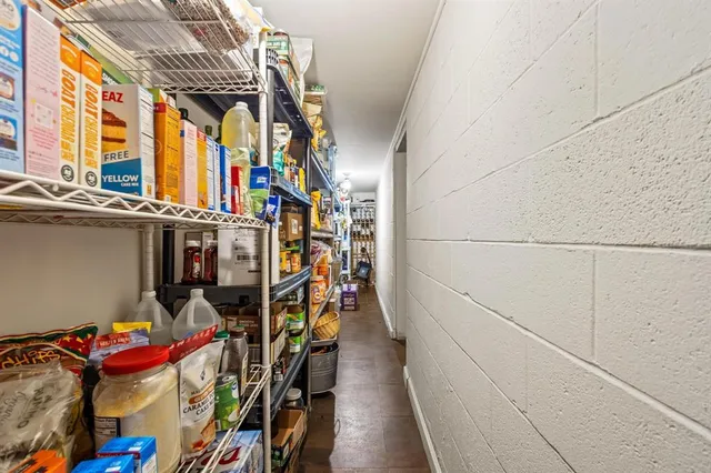 a view of walk in closet with clothes