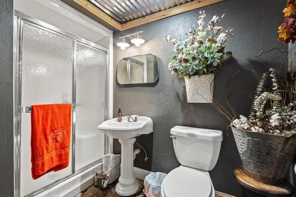 a bathroom with a toilet sink and mirror