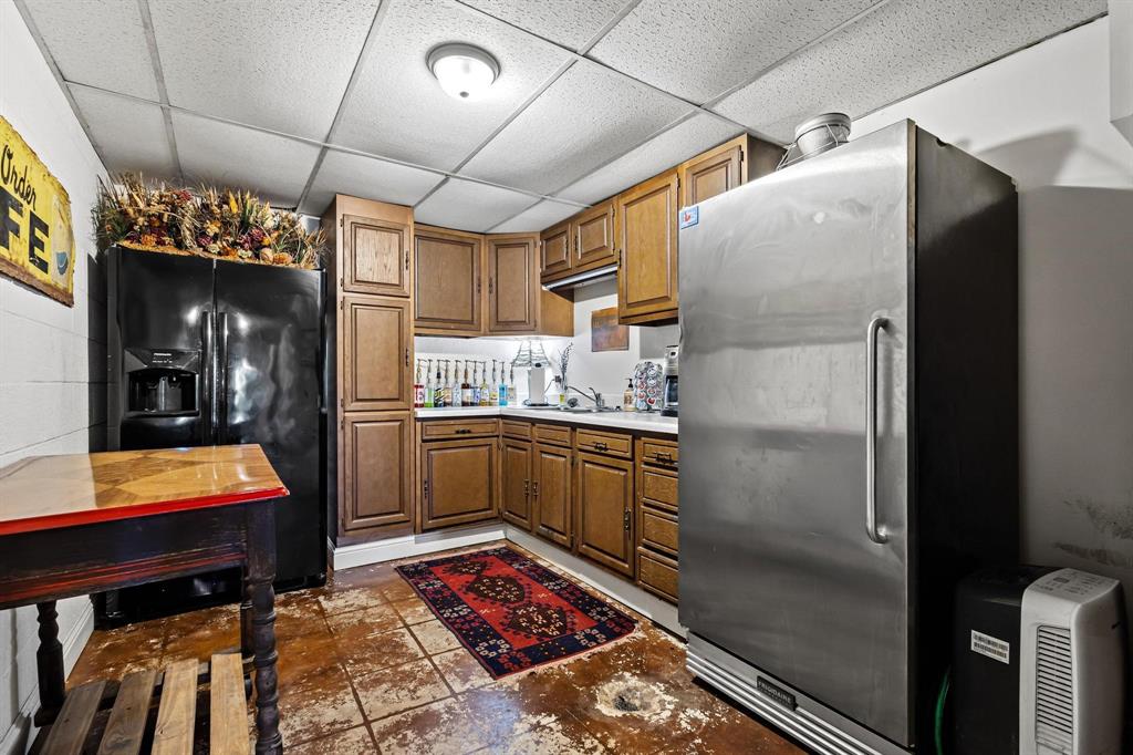 2321 County Road 2100 Ivanhoe, TX 75447 - Photo 25 of 40 a kitchen with refrigerator and table