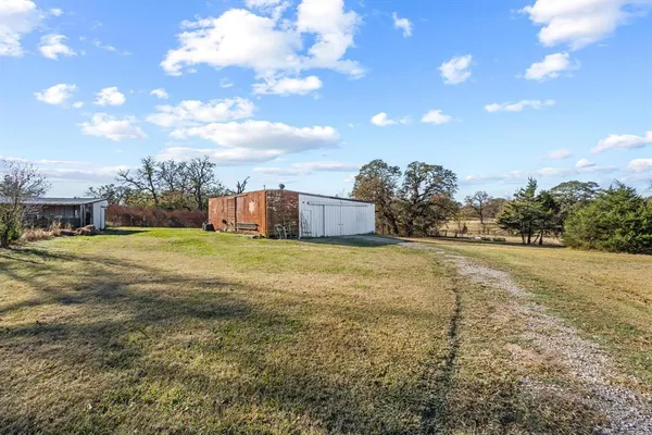 a view of a big yard with table and chairs