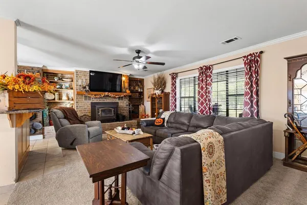 a living room with fireplace furniture and a flat screen tv