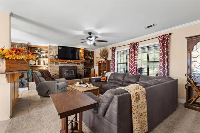 a living room with fireplace furniture and a flat screen tv