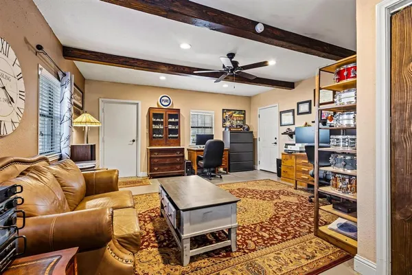 a living room with furniture a ceiling fan and a rug
