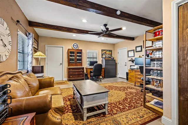 a living room with furniture a ceiling fan and a rug
