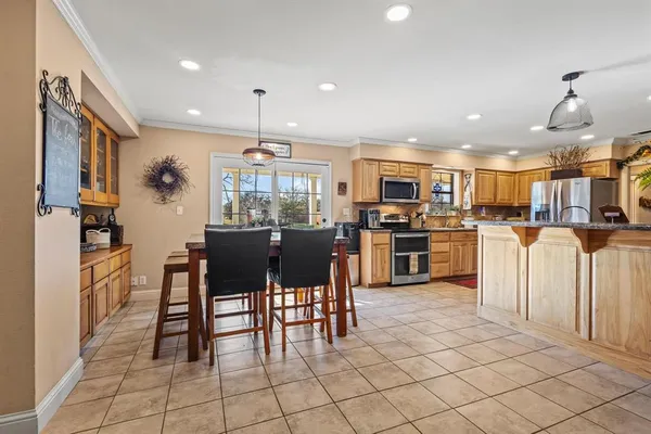 a kitchen with cabinets and chairs