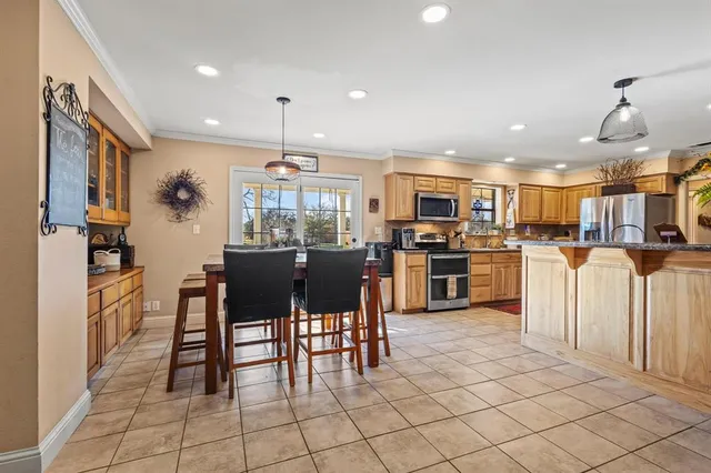 a kitchen with cabinets and chairs