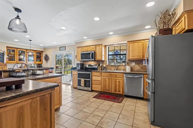 a kitchen with granite countertop lots of counter top space and stainless steel appliances