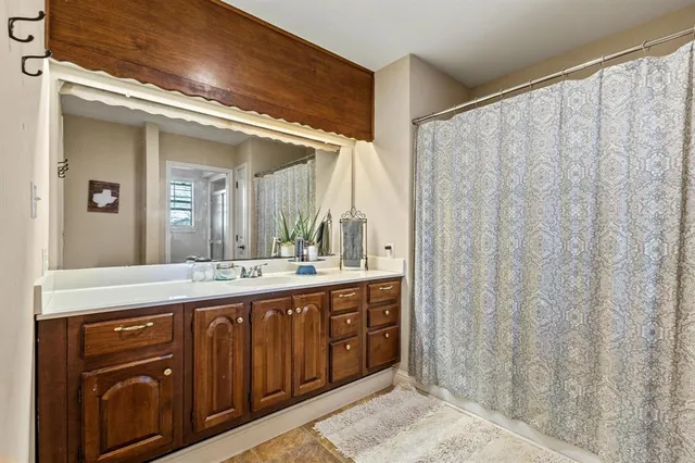 a spacious bathroom with a double vanity sink and a mirror