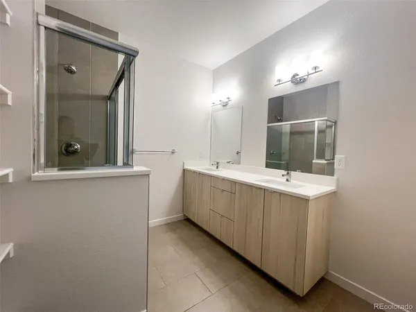 a bathroom with a double vanity sink and mirror