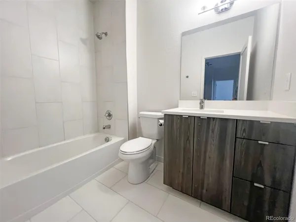 a bathroom with a toilet a sink and bathtub