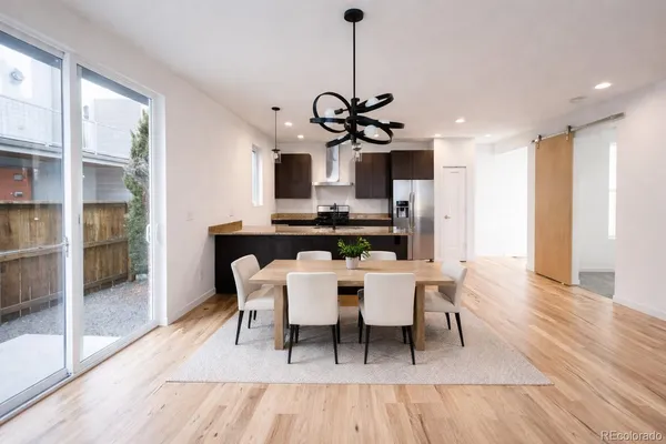 a view of a dining room with furniture wooden floor and chandelier
