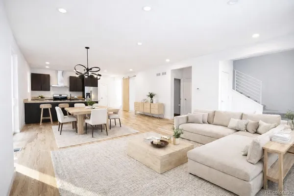 a living room with furniture and kitchen view