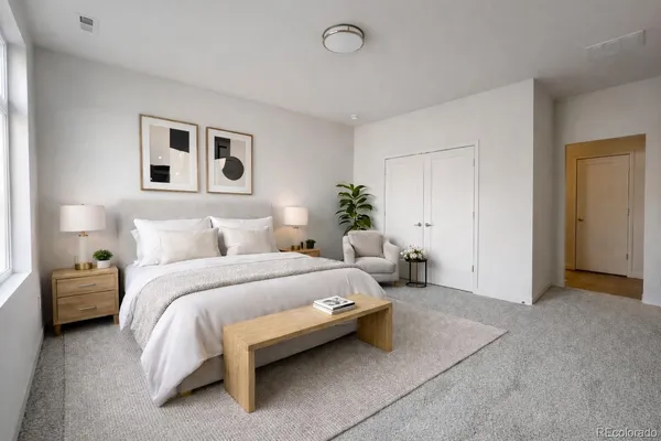 a spacious bedroom with a bed and window