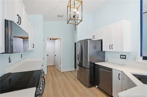 a kitchen with stainless steel appliances a refrigerator sink and cabinets