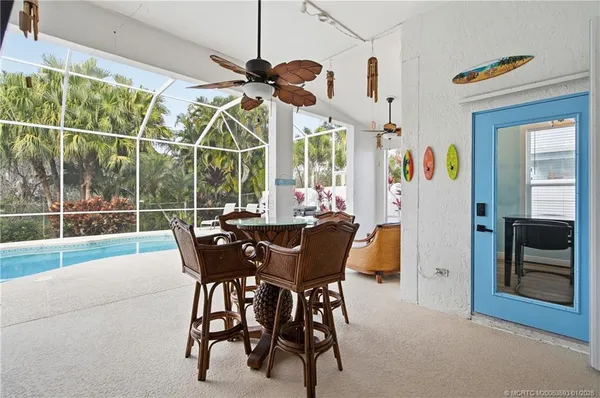 a view of a room with furniture and a chandelier