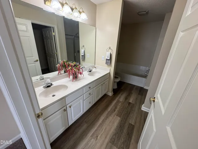 a bathroom with a double vanity sink and mirror