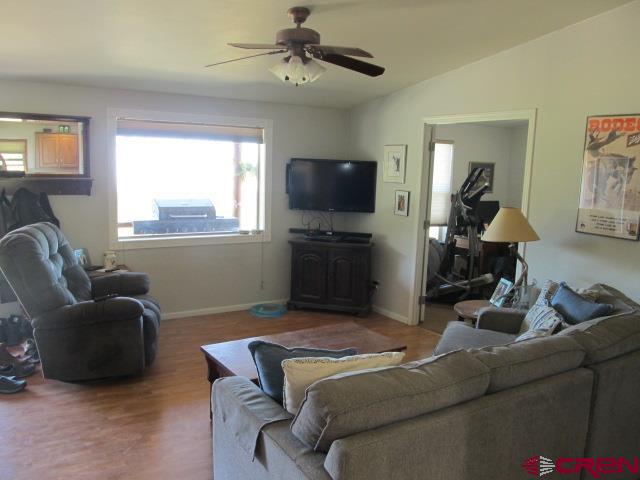 21578 Highway 65 Cedaredge, CO 81413 - Photo 17 of 35 a living room with furniture a flat screen tv and a window