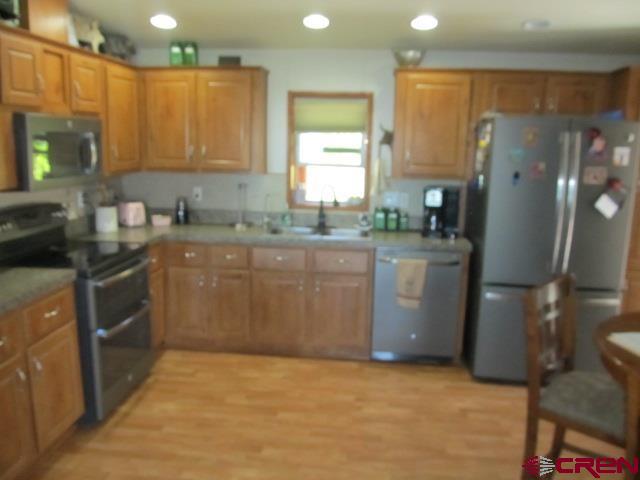 21578 Highway 65 Cedaredge, CO 81413 - Photo 19 of 35 a kitchen with a sink a stove a refrigerator a window