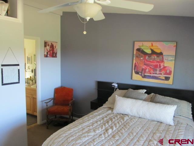 21578 Highway 65 Cedaredge, CO 81413 - Photo 21 of 35 a bedroom with bed and wall painting