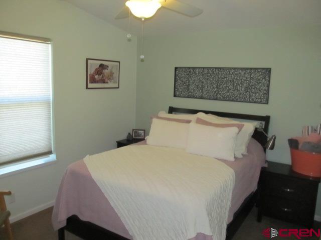 21578 Highway 65 Cedaredge, CO 81413 - Photo 23 of 35 a large bed sitting in a bedroom next to a window