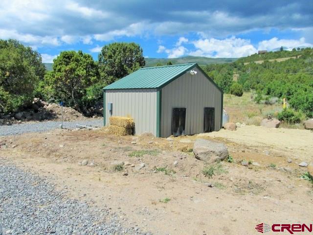 21578 Highway 65 Cedaredge, CO 81413 - Photo 26 of 35 a view of a dry yard with large trees