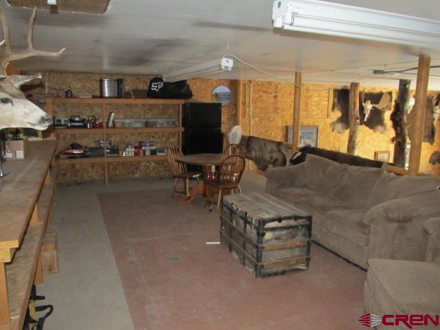 21578 Highway 65 Cedaredge, CO 81413 - Photo 31 of 35 a living room with furniture and a flat screen tv
