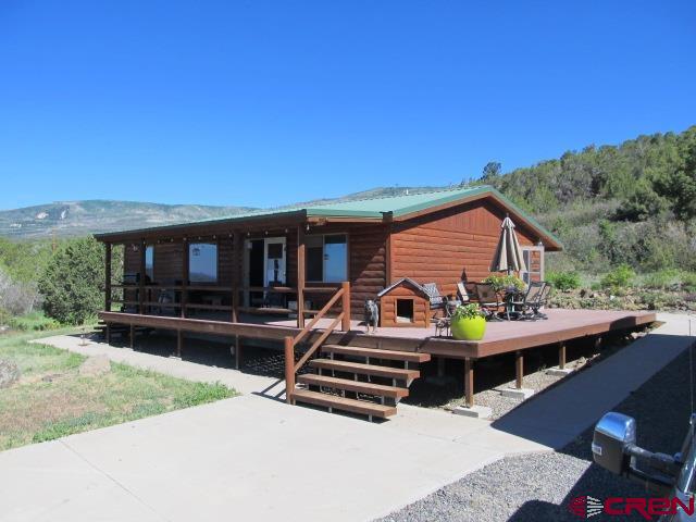 21578 Highway 65 Cedaredge, CO 81413 - Photo 6 of 35 a view of house and outdoor space with swimming pool