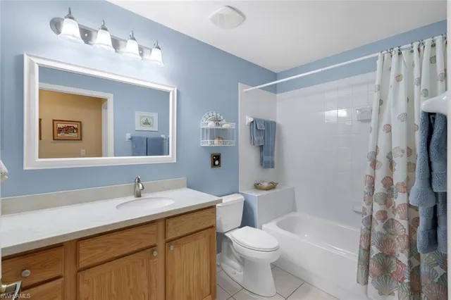 a bathroom with a double vanity sink toilet and shower