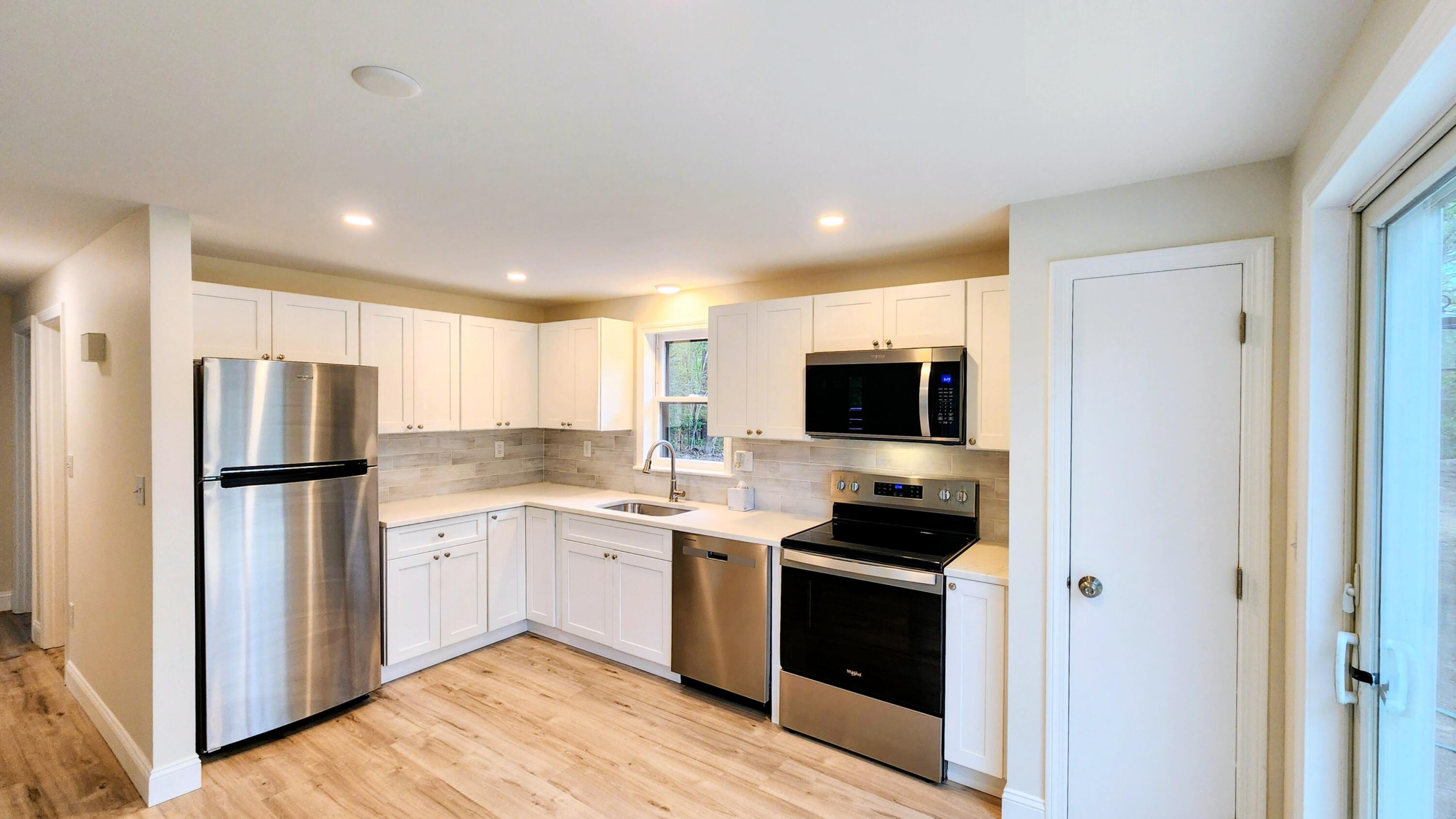 147 Chippingstone Road Marstons Mills, MA 02648 - Photo 8 of 23 a kitchen with a refrigerator and a stove top oven