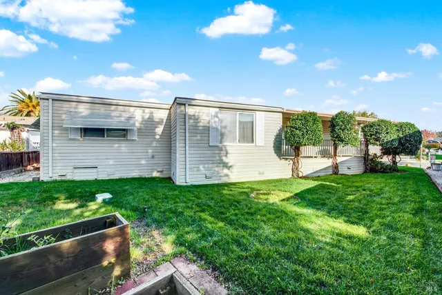 a living room with furniture and a ceiling fan