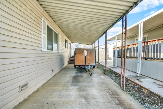 a kitchen with a refrigerator a stove top oven a sink and cabinets with wooden floor