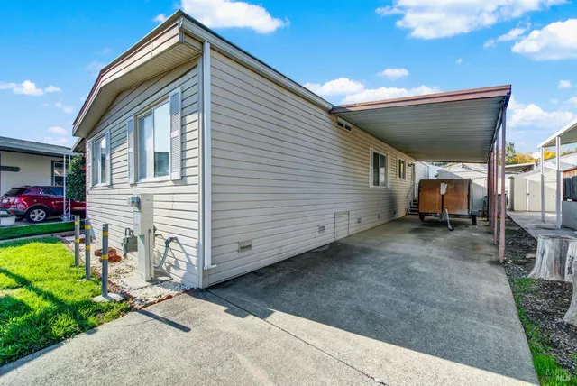 a view of a house with a yard and a garden