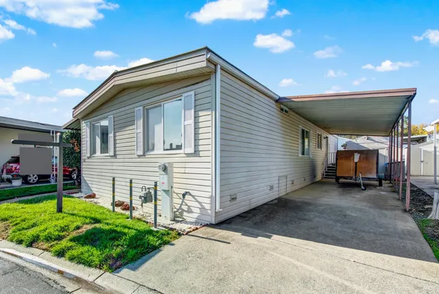 a view of backyard with plants and outdoor seating