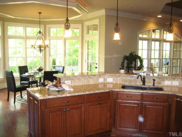 2718 Anderson Drive Raleigh, NC 27608 - Photo 6 of 12 a kitchen with granite countertop a sink cabinets and wooden floor