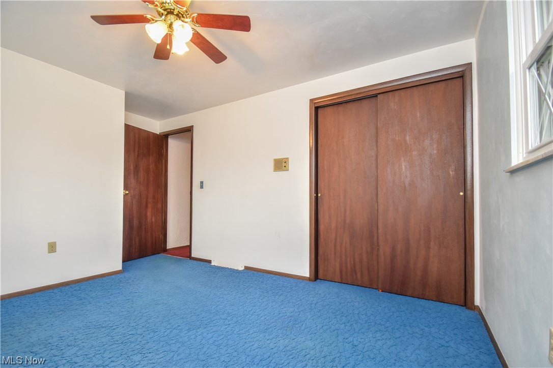 47700 Summerset Road East Liverpool, OH 43920 - Photo 19 of 35 Unfurnished bedroom with a closet, carpet flooring, and ceiling fan