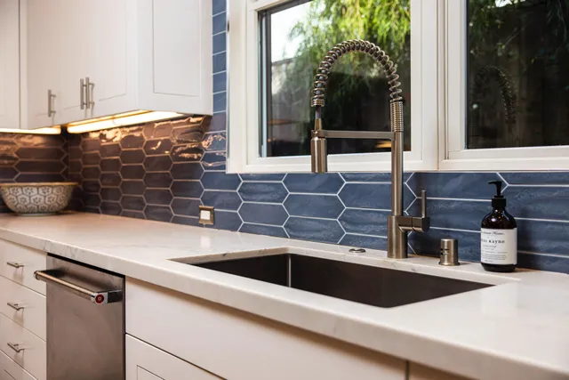 a kitchen with a sink and large window