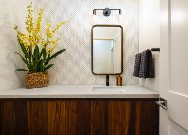 a bathroom with a sink a mirror and vanity
