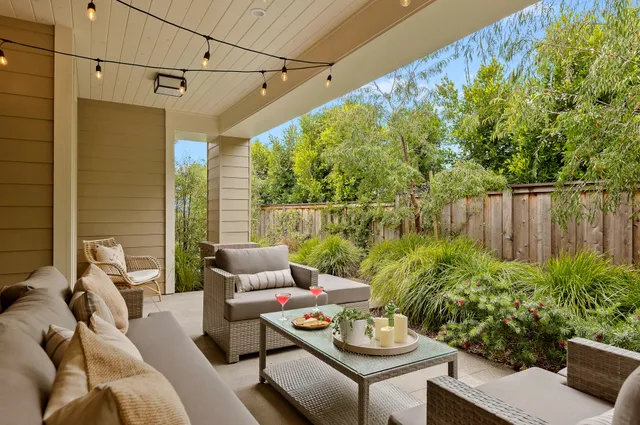 a living room with furniture and a potted plant