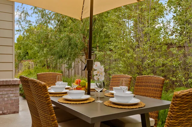a view of a dining table and chairs in the patio