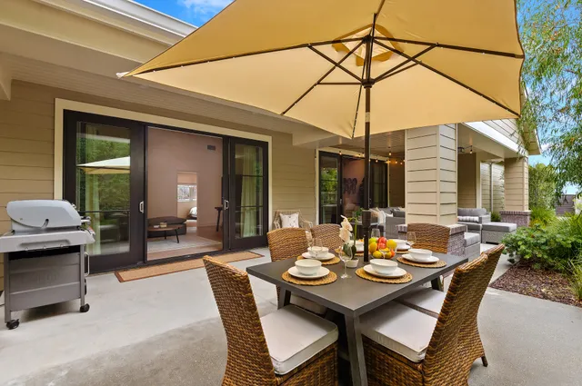 a view of a dinning table and chairs in the patio