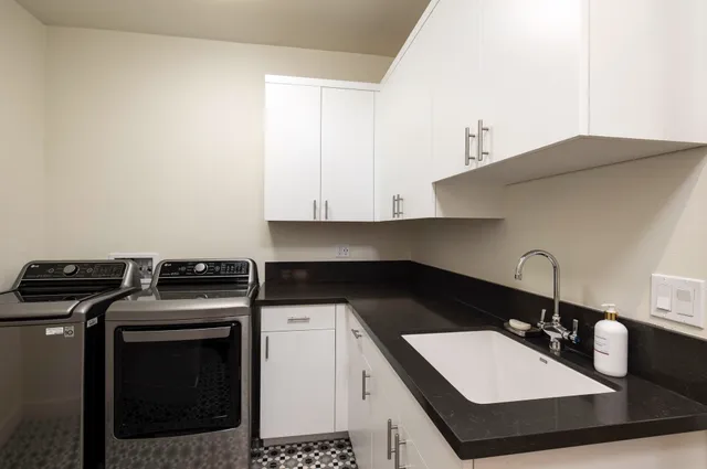 a kitchen with a sink stove and cabinets