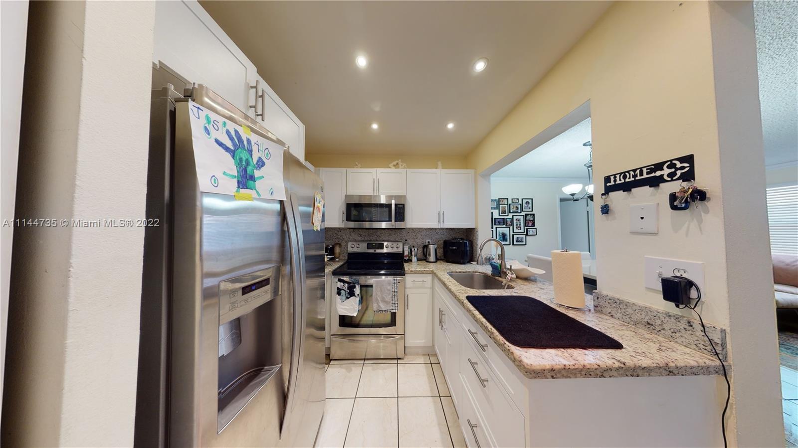 14911 Southwest 104th Street, Unit 1722 Miami, FL 33196 - Photo 17 of 29 a kitchen with stainless steel appliances a refrigerator sink and stove