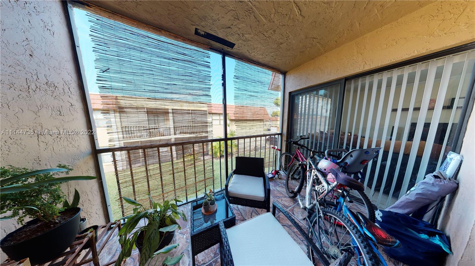 14911 Southwest 104th Street, Unit 1722 Miami, FL 33196 - Photo 18 of 29 a outdoor living space with furniture