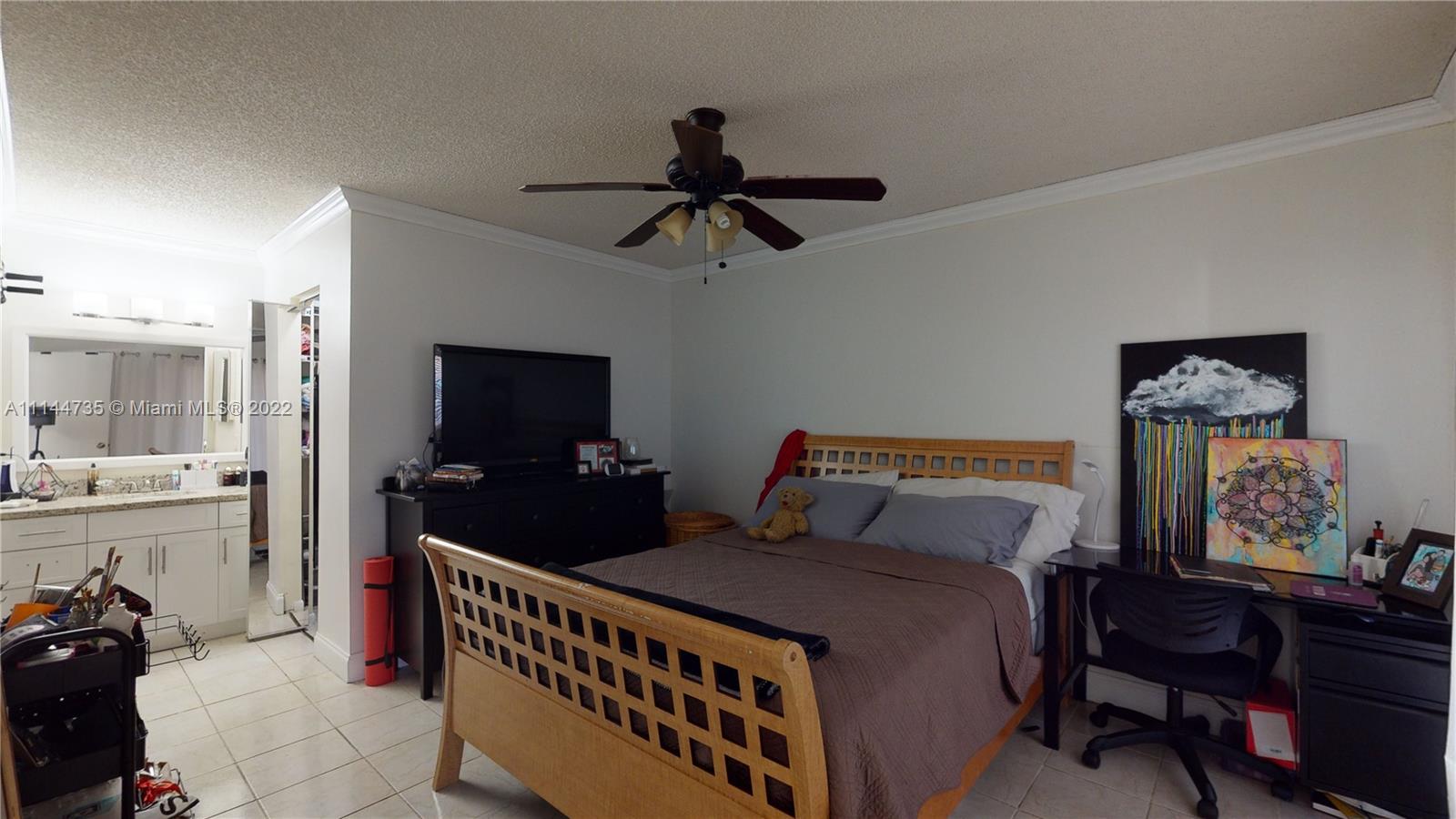 14911 Southwest 104th Street, Unit 1722 Miami, FL 33196 - Photo 19 of 29 a bedroom with a bed and wooden floor