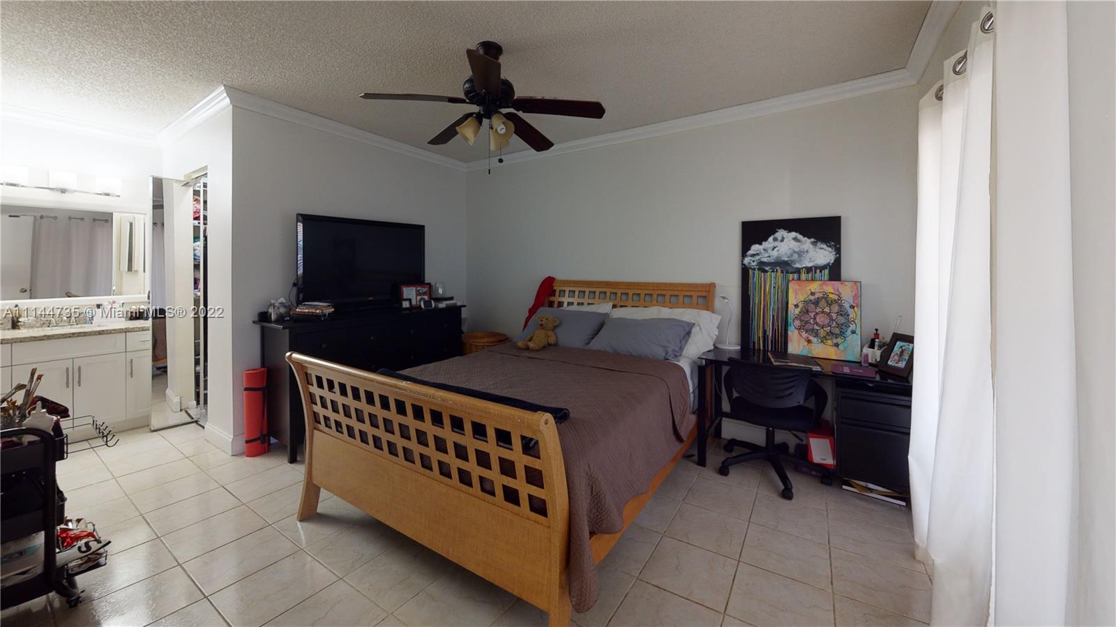 14911 Southwest 104th Street, Unit 1722 Miami, FL 33196 - Photo 20 of 29 a bed room with a bed and a tv