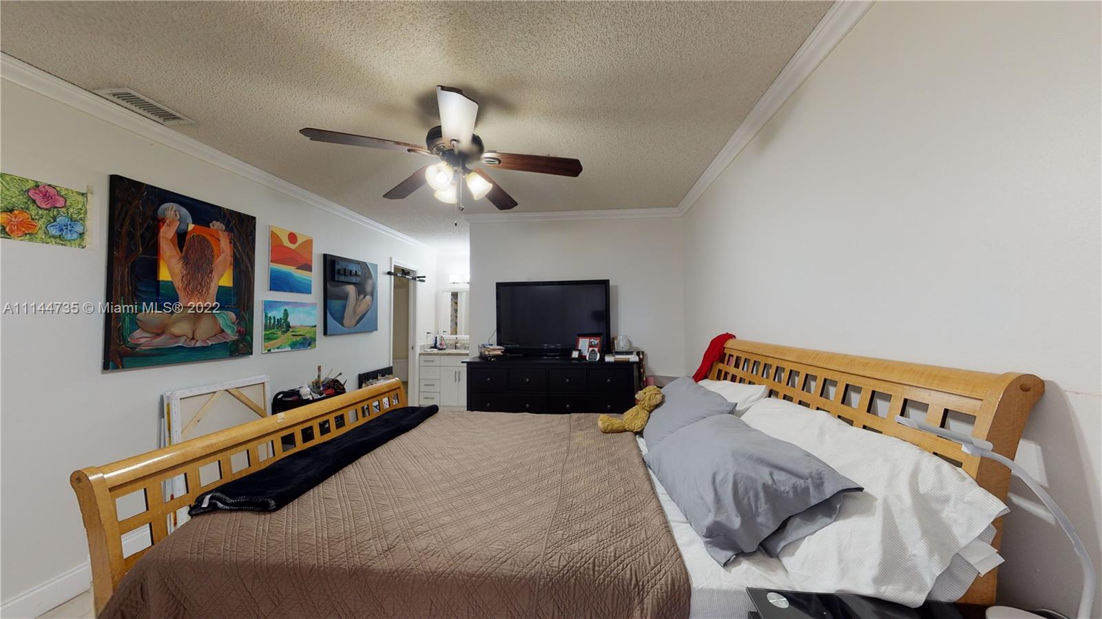 14911 Southwest 104th Street, Unit 1722 Miami, FL 33196 - Photo 21 of 29 a bedroom with furniture and a flat screen tv