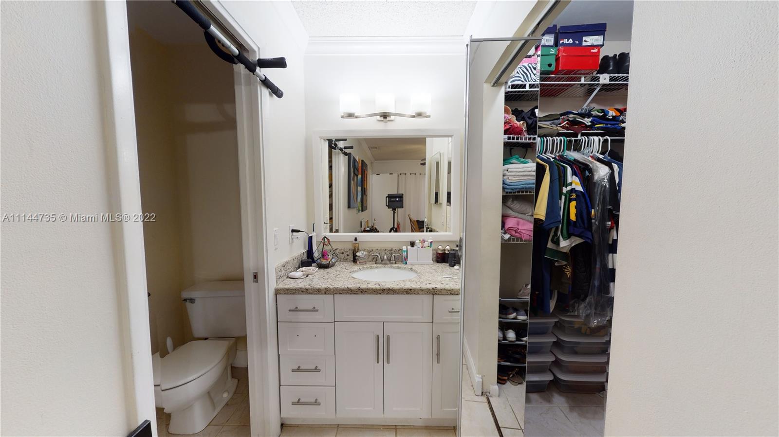 14911 Southwest 104th Street, Unit 1722 Miami, FL 33196 - Photo 22 of 29 a en suite bathroom with a granite countertop sink and a mirror