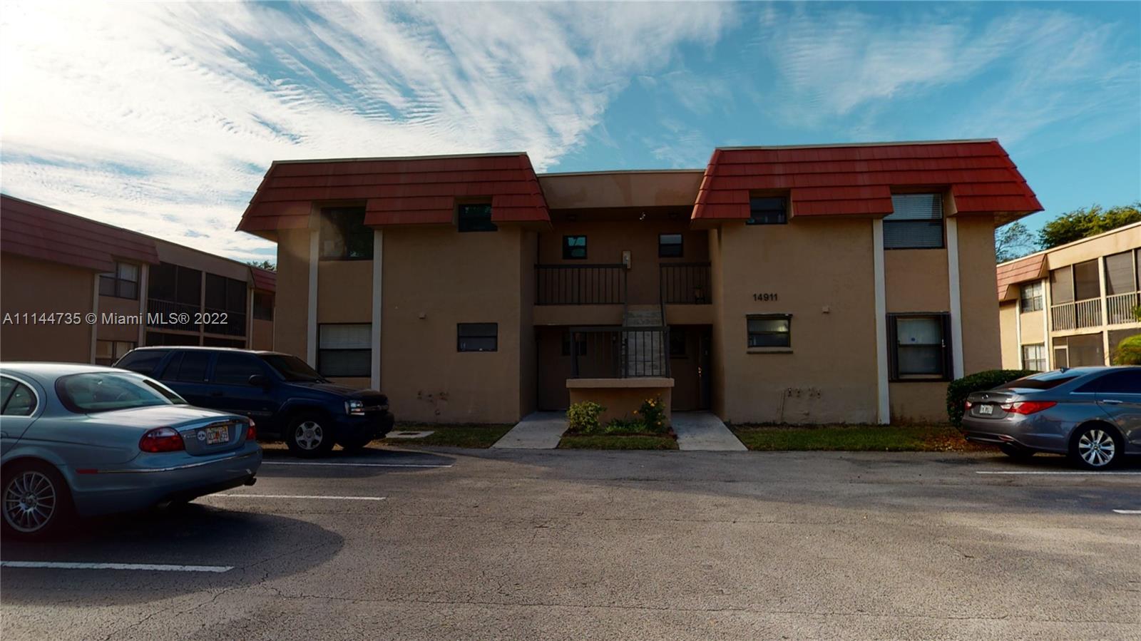 14911 Southwest 104th Street, Unit 1722 Miami, FL 33196 - Photo 4 of 29 a view of a car park in front of house